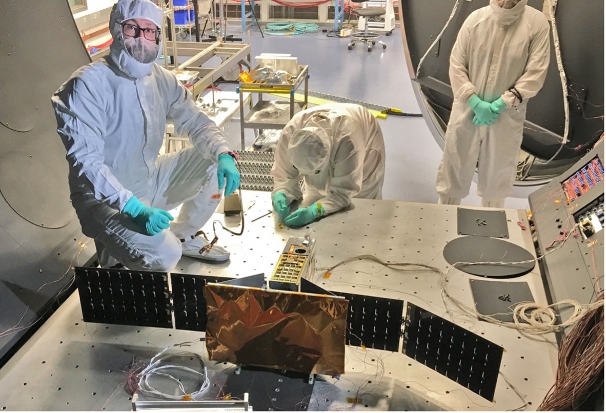  A team of LASP researchers at the University of Colorado, Boulder, get ready to test their Compact Spectral Irradiance Monitor (CSIM) instrument within a vacuum chamber. (Credit: University of Colorado / LASP)