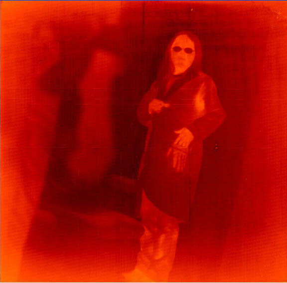 A false color image of a Goddard engineer in the far infrared (8-12 micrometer IR spectral band) taken with the 1-megapixel QWIP in 2006. Warmer temperatures are orange, cooler temperatures are dark red. Notice the thermal handprint on her lab coat as she removes her hand from her pocket. (Credit: NASA)