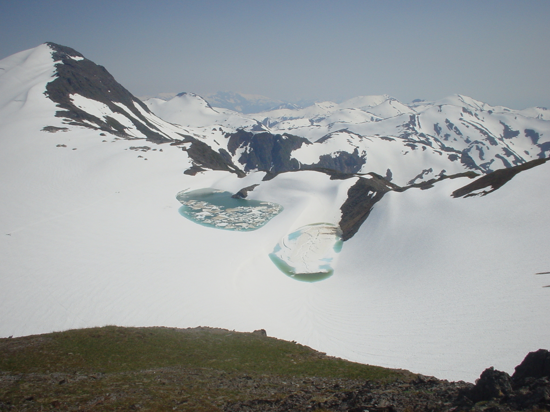 Large ponds of liquid water that form on the top of a glacier, supraglacial lakes can form slowly and drain catastrophically, flooding the watershed below. These two supraglacial lakes formed on Lemon Creek Glacier in 2009. (Credit: Matt Heavner)