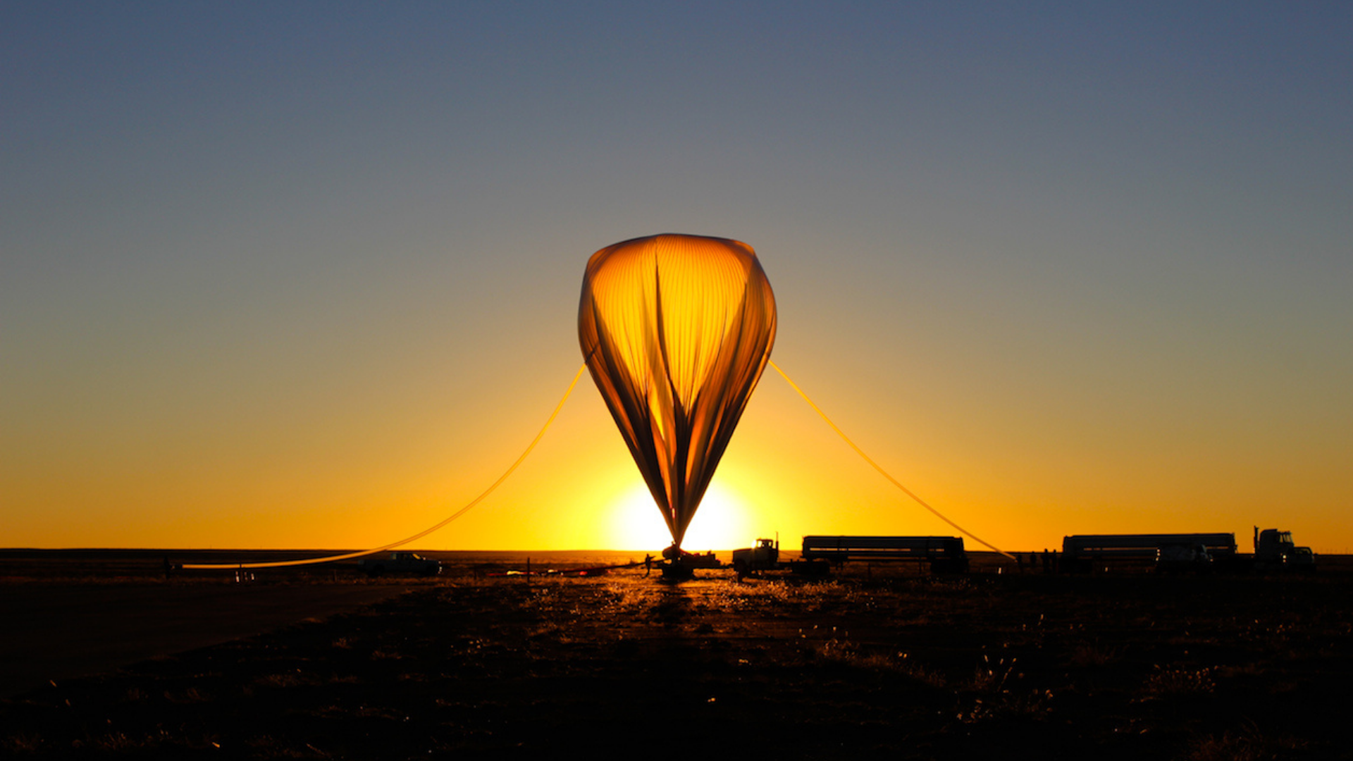 The sun rises in Fort Sumner, NM, as the HySICS payload is readied for launch on a high-altitude baloon. (2014, Credit: NASA)